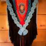 Black/orange Macrame with bead embroidery around a dichroic glass centerpiece